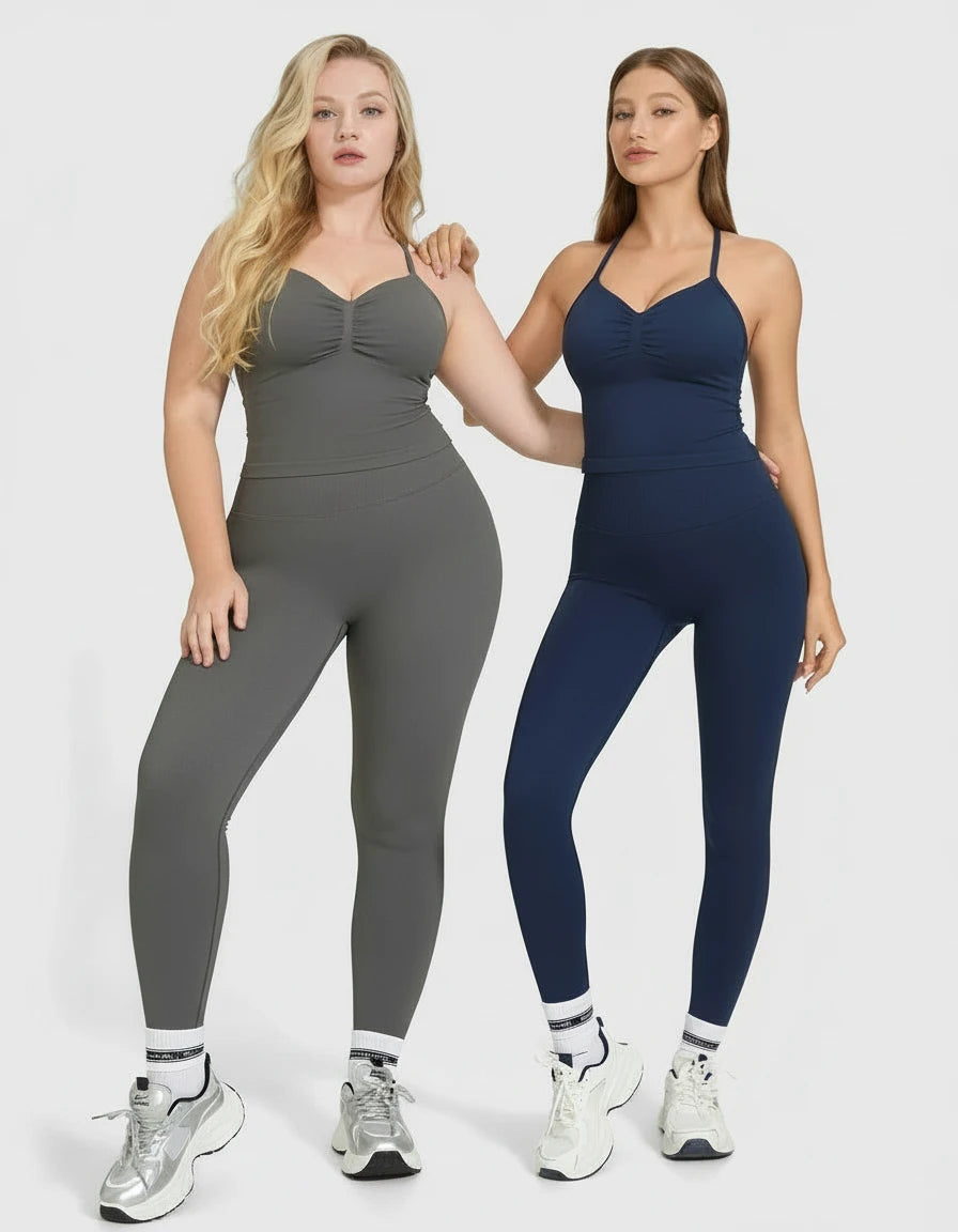 Two women wearing gray and navy athletic outfits on a white background