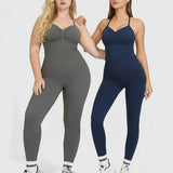 Two women wearing gray and navy athletic outfits on a white background