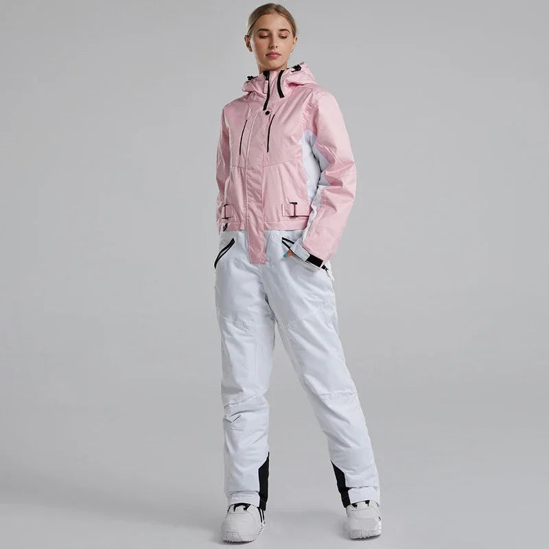Person wearing a pink jacket and white pants on a gray background