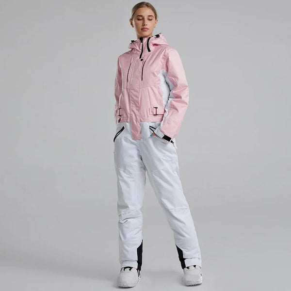 Person wearing a pink jacket and white pants on a gray background