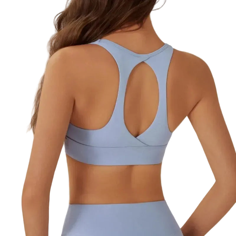 Light blue sports bra worn by a person on a plain background
