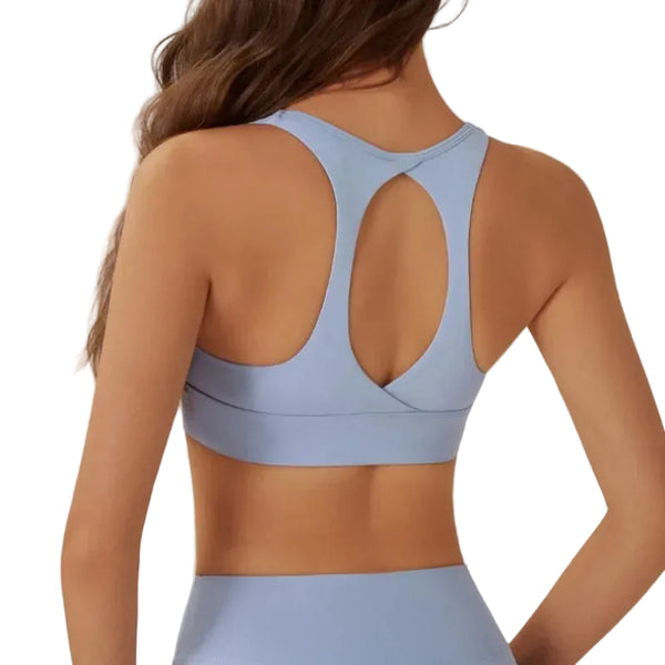 Light blue sports bra worn by a person on a plain background