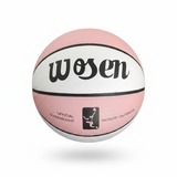 Pink and white basketball with 'wosen' branding held by a hand against a chain-link fence background.