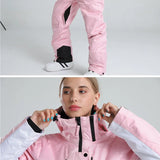 Pink snowsuit with black accents worn by a person, with a close-up of a woman wearing the pink jacket.