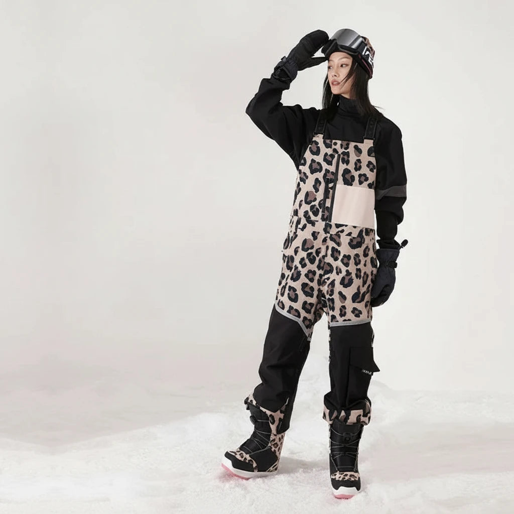 Person wearing leopard print snow overalls with text highlighting windproof and warm properties on a white background.