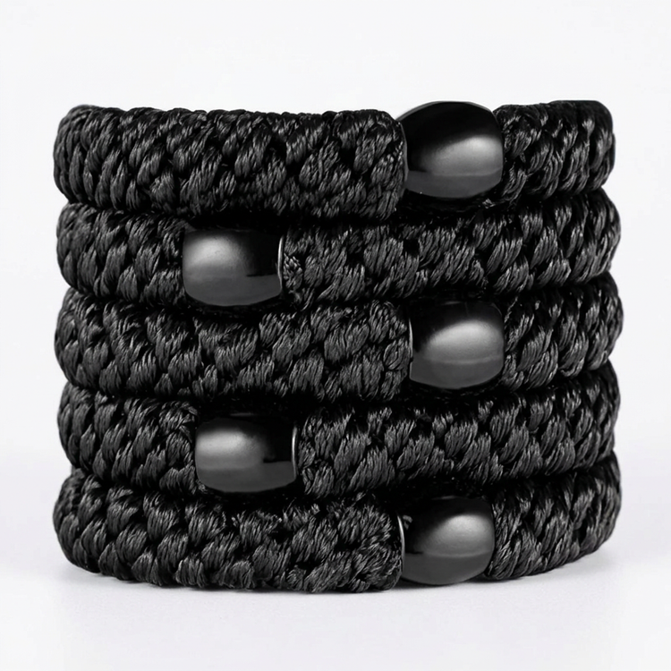 Five black braided hair ties on white