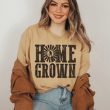 Woman wearing a beige sweatshirt with 'HOME GROWN' text on a plain background