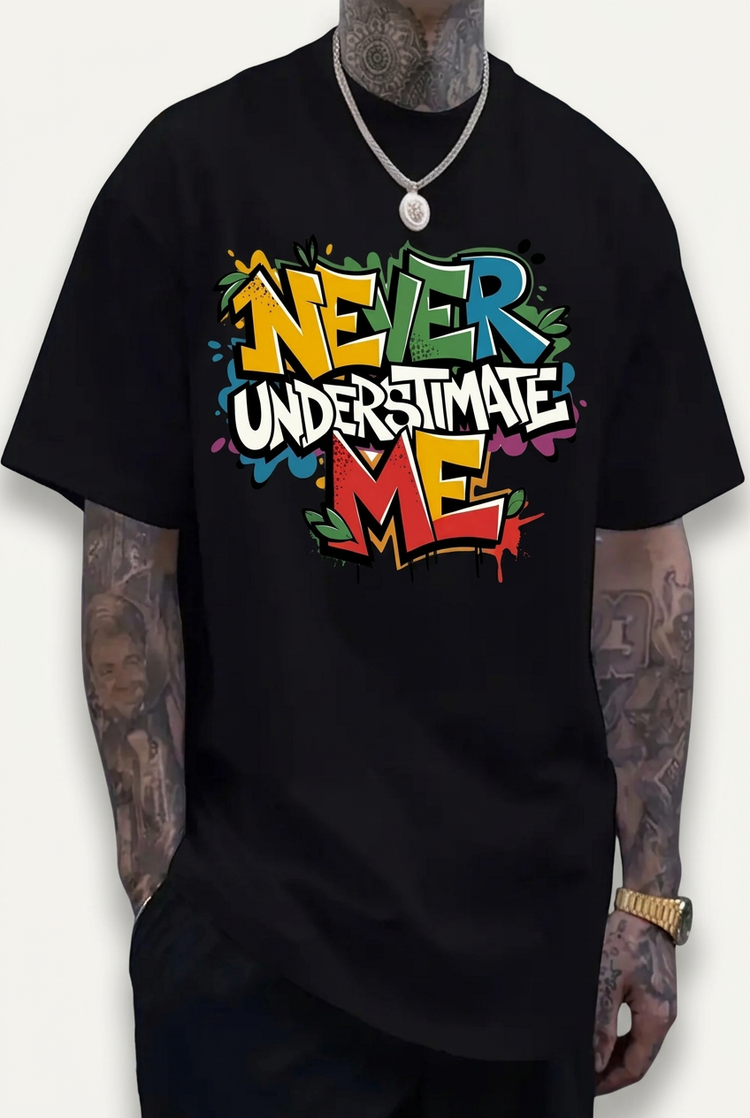 Model wearing a black Never Underestimate Me graphic T-shirt