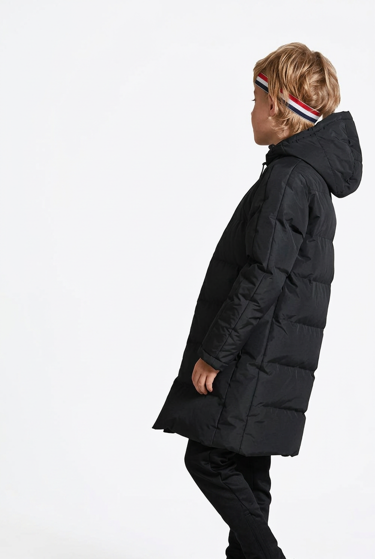 Side view of a child wearing a black hooded coat