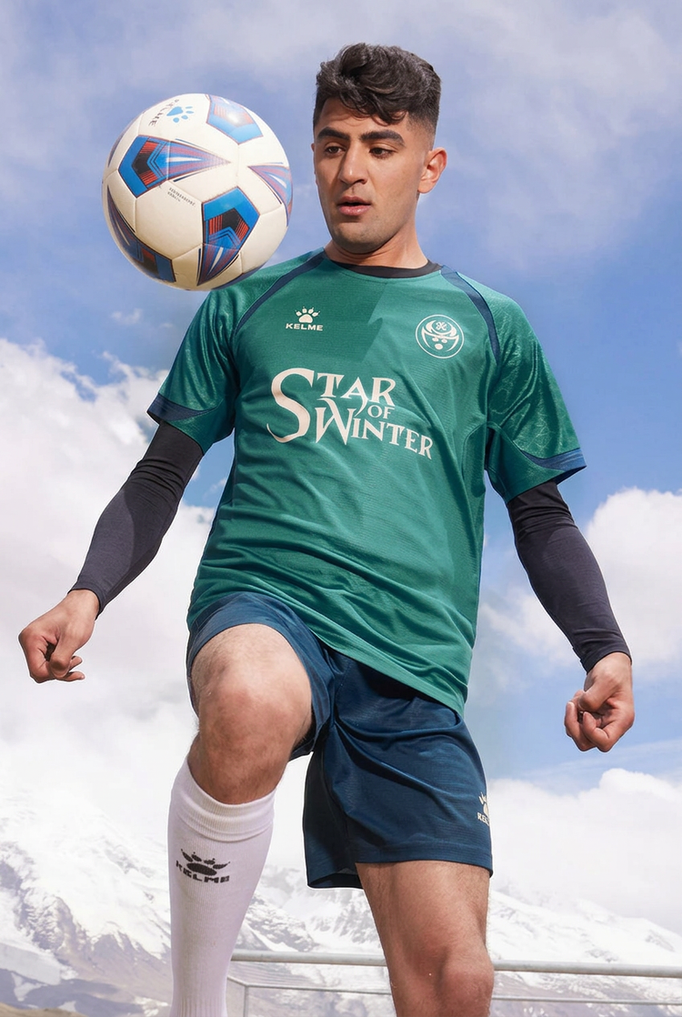 Soccer player wearing a dark green jersey and navy shorts